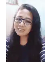 a woman wearing glasses and a striped shirt smiles at the camera