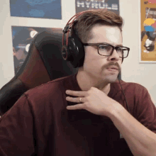 a man wearing glasses and headphones looks at something