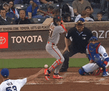 a baseball game is being played in front of a toyota advertisement