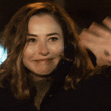 a close up of a woman 's face with a smile