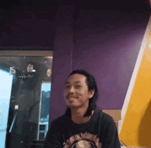 a man wearing a t-shirt that says ' a ' on it
