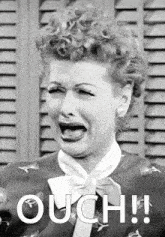 a black and white photo of a woman with the word ouch on the bottom right