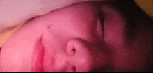 a close up of a person 's face with their eyes closed