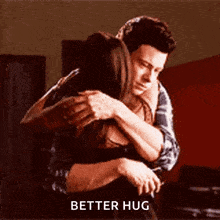 a man and a woman hugging each other with the words `` better hug '' written on the bottom .