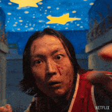 a man with blood on his face is in a netflix ad