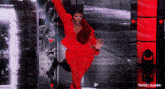 a woman in a red suit is dancing on a stage with the words t4yce tumblr in the corner