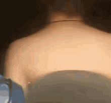 a close up of a person 's back with a necklace on it .