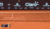 a tennis court with a santander banner behind it