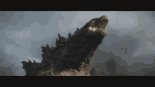 a close up of a monster with its mouth open looking up into the sky .