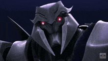 a close up of a robot with red eyes and the word transformers on the bottom