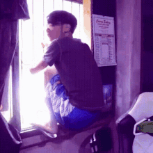 a man sits on a window sill in front of a calendar that says chinese baking on it