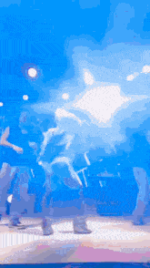 a blurry picture of people dancing on a stage