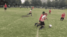 a group of young boys are playing a game of soccer on a field .