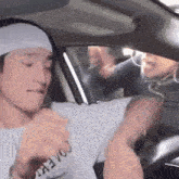 a man wearing a white headband and a white t-shirt that says covery