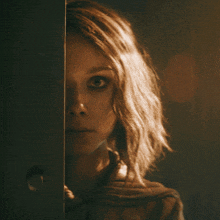 a close up of a woman 's face with a dark background