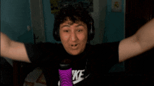 a man wearing headphones and a shirt that says nike on it