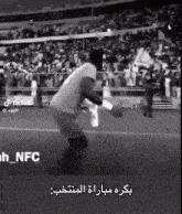 a black and white photo of a man on a soccer field with tiktok written on the bottom