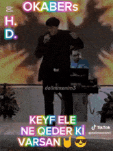 a man singing into a microphone with the words okabers h.d. keyf ele ne qeder ki varsan below him