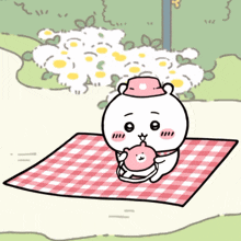 a cartoon bear is sitting on a checkered blanket