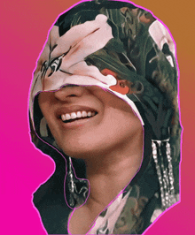 a woman with a floral scarf on her face is smiling