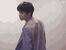 a man in a suit and tie is looking over his shoulder