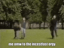 a group of people are standing in a grassy field .