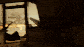 a blurred image of a person standing in front of a window