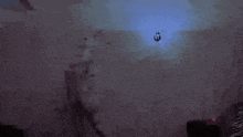a person is flying through the air in a dark room