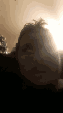 a close up of a person 's face with a light behind them
