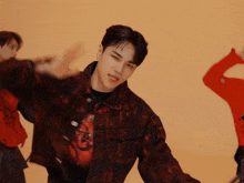 a man wearing a black shirt with a red dragon on it is dancing