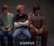 three young men are sitting next to each other with the word doofus written on the bottom