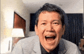 a man is making a funny face with his mouth wide open