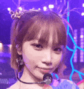 a close up of a woman 's face with a microphone on her neck