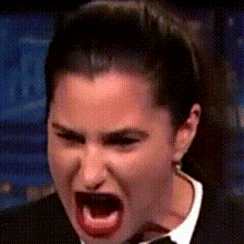 a woman is making a funny face with her mouth wide open