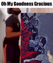 a man standing next to a painting that says oh my goodness gracious