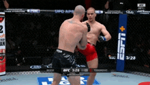two men are fighting in a boxing ring with a sign that says espn