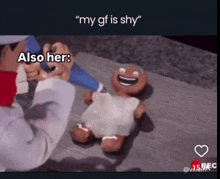 a gingerbread man is being decorated by a man with the caption " my gf is shy also her "