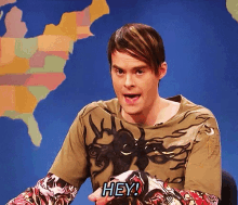 a man in a colorful shirt says hey