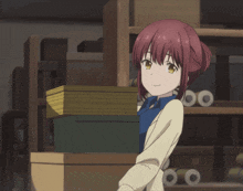 a girl with red hair is smiling while holding a box
