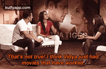 a group of people are sitting on a couch and talking to each other with the words that 's not true