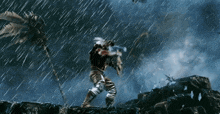 a man standing in the rain with a sword in his hand
