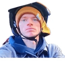 a man wearing a helmet and a beanie .