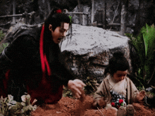 a man and a child are playing with dirt