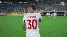 a soccer player with the number 30 on their jersey