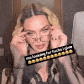 a woman wearing glasses has a caption that says me looking for fucks i give