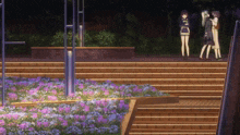 three women standing on a set of stairs with purple flowers