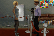 a man and a woman are standing next to each other behind a rope barrier