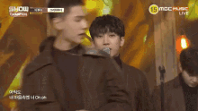 a man singing into a microphone with the words show champion on the bottom right