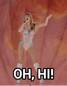 a woman singing into a microphone with the words oh hi written below her