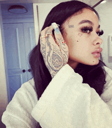 a woman with a tattoo on her face says love